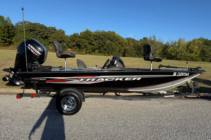 Slide: The Image of 2020 Tracker Pro Team 175 boat on trailer, parked outdoors, with Mercury outboard motor. - 22
