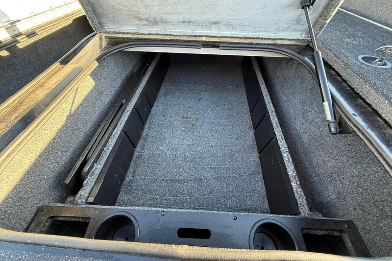Slide: The Image of 2020 Tracker Pro Team 175 boat storage compartment, open and empty, with carpeted interior. - 26