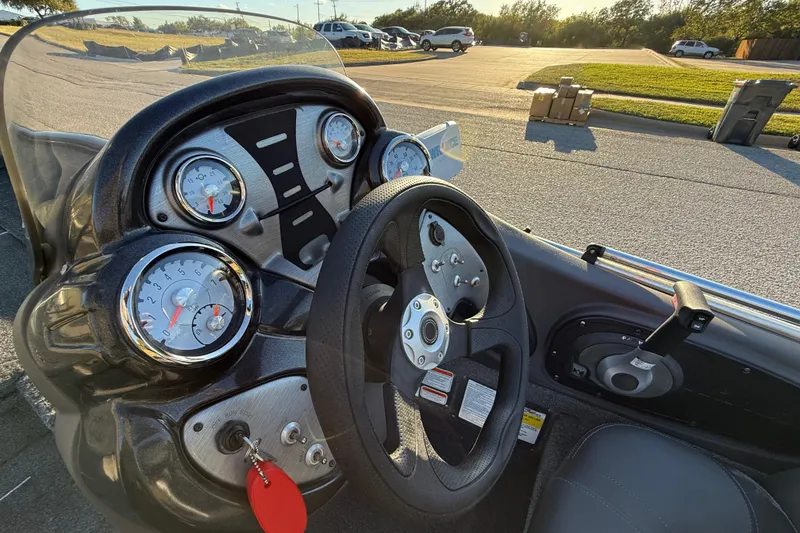 Slide: The Image of 2020 Tracker Pro Team 175 boat dashboard with steering wheel and gauges in sunlight. - 30