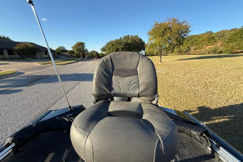 Slide: The Image of 2020 Tracker Pro Team 175 boat seat on a sunny day, parked on a suburban street. - 35