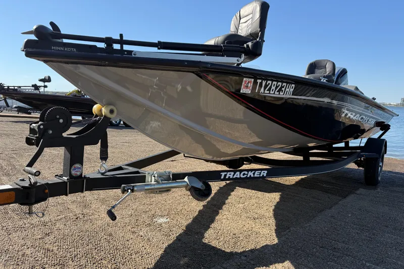 Slide: The Image of 2020 Tracker Pro Team 175 boat on trailer by the water, featuring Minn Kota motor. - 43