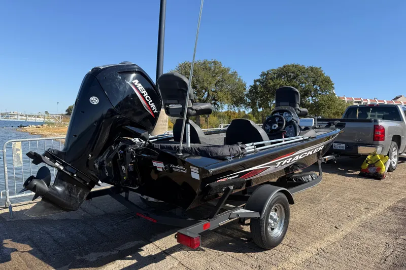 Slide: The Image of 2020 Tracker Pro Team 175 boat on trailer, parked near a lake with a truck. - 47