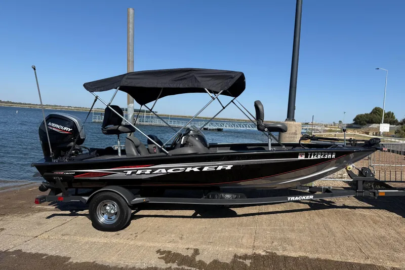 Slide: The Image of 2020 Tracker Pro Team 175 boat with Mercury engine on trailer by the water. - 56