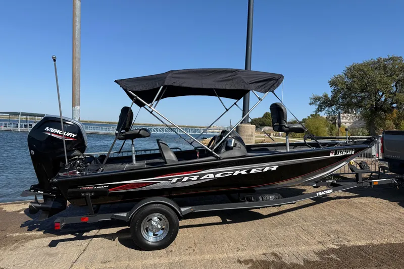 Slide: The Image of 2020 Tracker Pro Team 175 boat with Mercury engine on trailer by the water. - 57