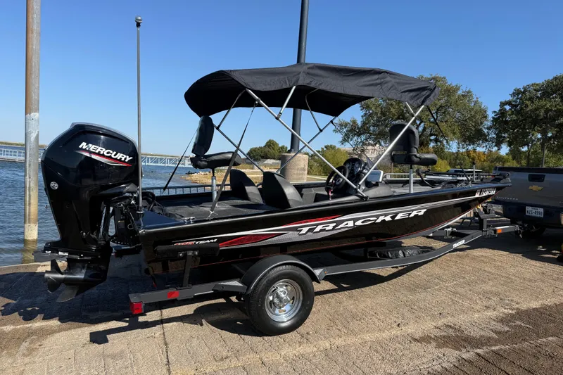 Slide: The Image of 2020 Tracker Pro Team 175 boat with Mercury engine on trailer by the water. - 58