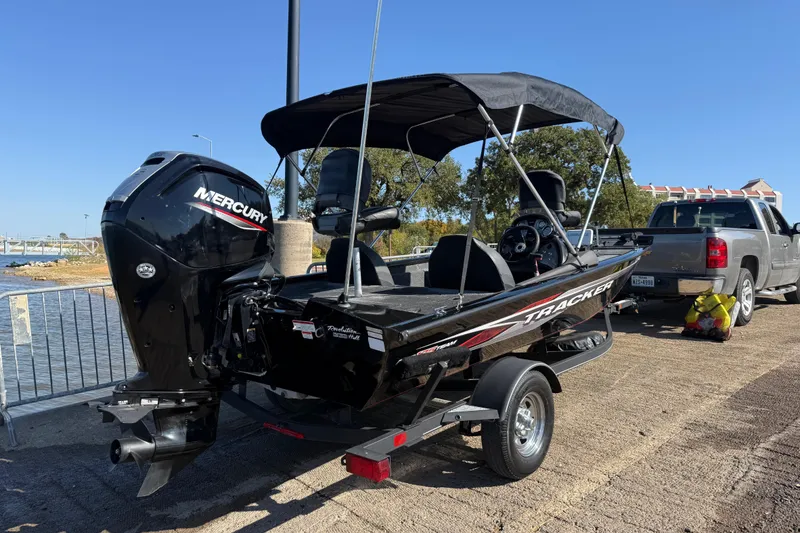 Slide: The Image of 2020 Tracker Pro Team 175 boat with Mercury engine on trailer by a lake. - 59