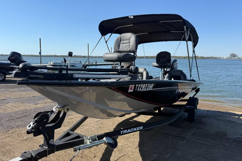 Slide: The Image of 2020 Tracker Pro Team 175 boat on trailer by the water, featuring Minn Kota motor. - 61