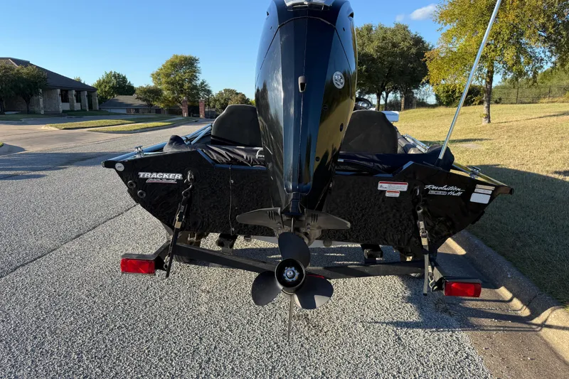 Slide: The Image of 2020 Tracker Pro Team 175 boat on a trailer, parked on a suburban street. - 9