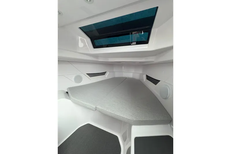 Slide: The Image of Interior cabin of 2025 Axopar 25 Cross Top boat with skylight and cushioned seating. - 10