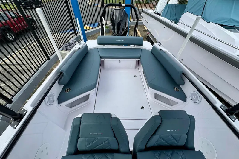 Slide: The Image of 2025 Axopar 25 Cross Top boat interior with blue seating and modern design. - 2