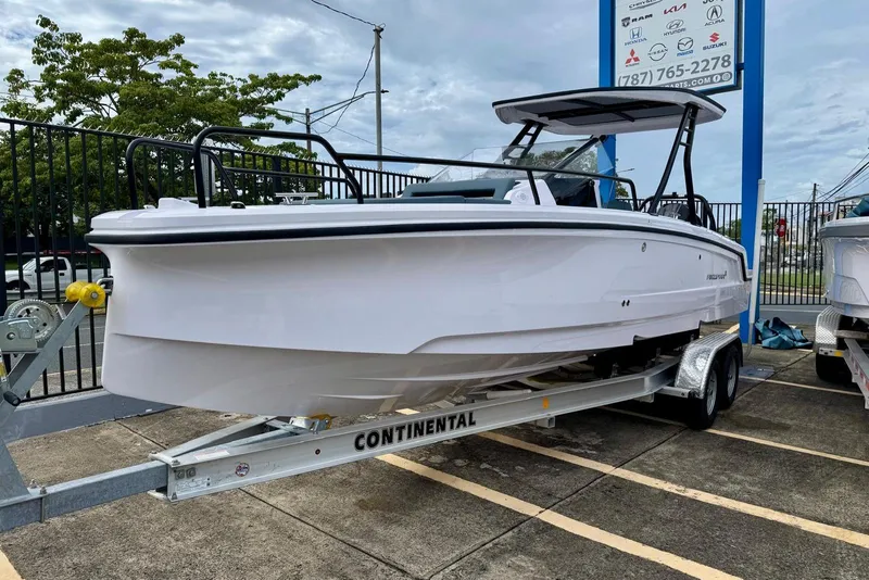 Slide: The Image of 2025 Axopar 25 Cross Top boat on trailer, displayed outdoors. - 5