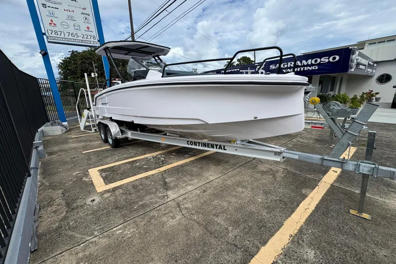 Slide: The Image of 2025 Axopar 25 Cross Top boat on trailer at dealership parking lot. - 6