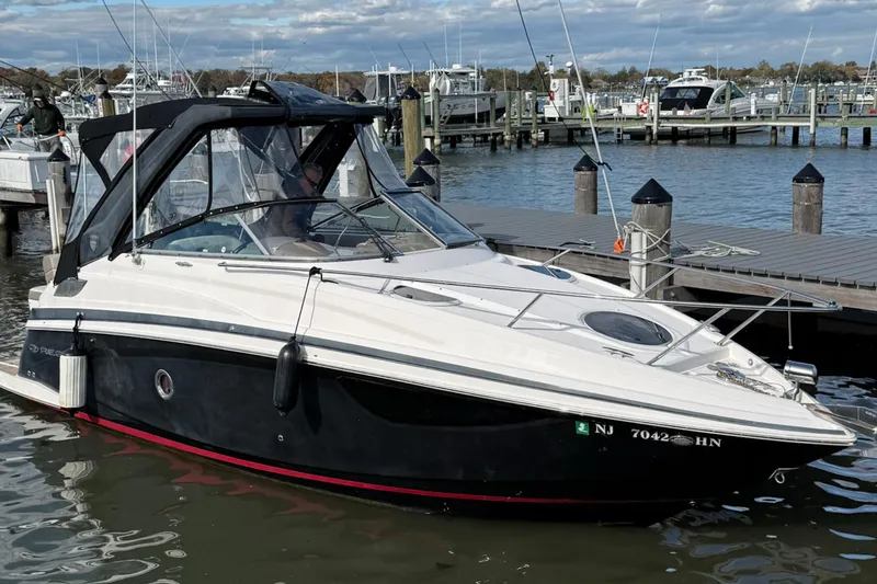 The Image of 2017 Regal 28 Express boat docked at a marina with clear skies. - 0