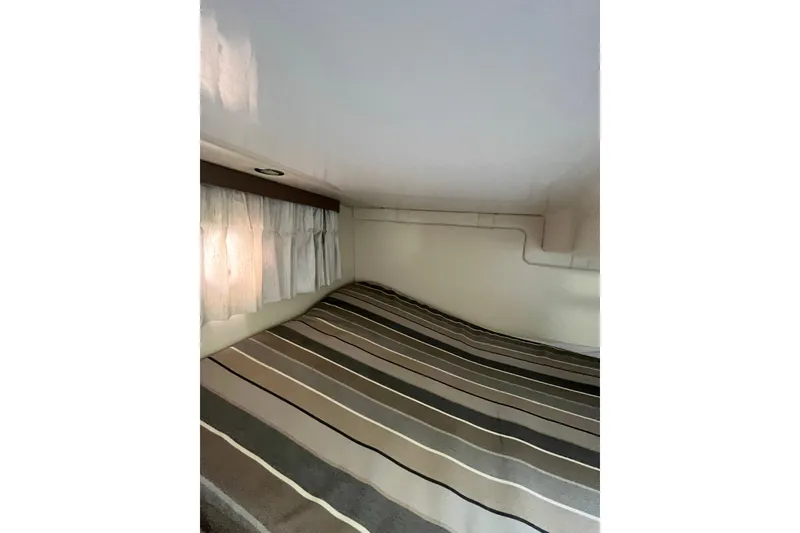 Slide: The Image of 2017 Regal 28 Express cabin interior with beige seating and wood flooring. - 12