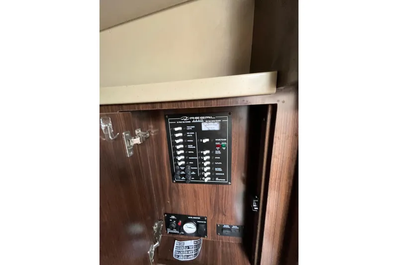 Slide: The Image of 2017 Regal 28 Express boat interior with beige seating and wood flooring. - 13