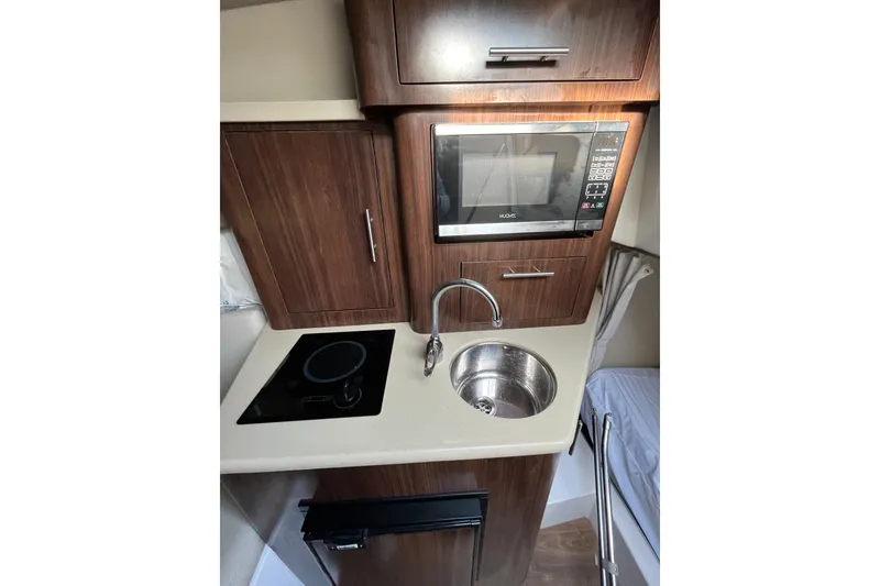 Slide: The Image of Interior of a 2017 Regal 28 Express boat with seating and dashboard view. - 14