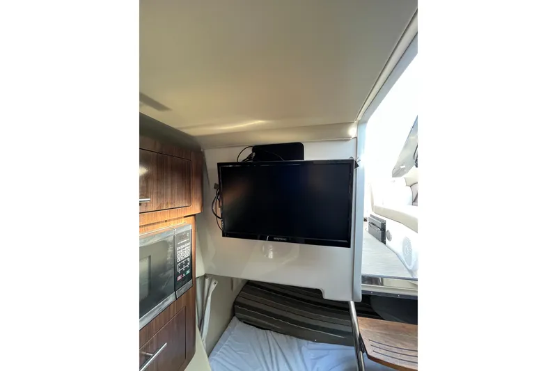 Slide: The Image of 2017 Regal 28 Express boat interior with cushioned seating and sleek design. - 15