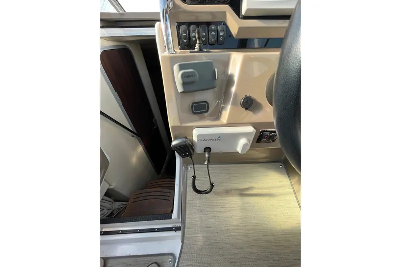 Slide: The Image of 2017 Regal 28 Express boat interior with steering wheel and dashboard view. - 21