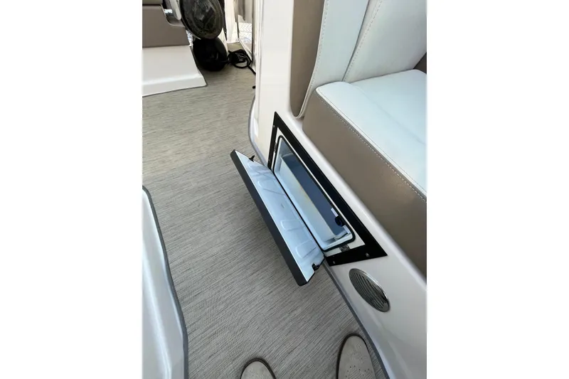 Slide: The Image of 2017 Regal 28 Express boat interior with kitchenette, featuring sink, stove, and microwave. - 24