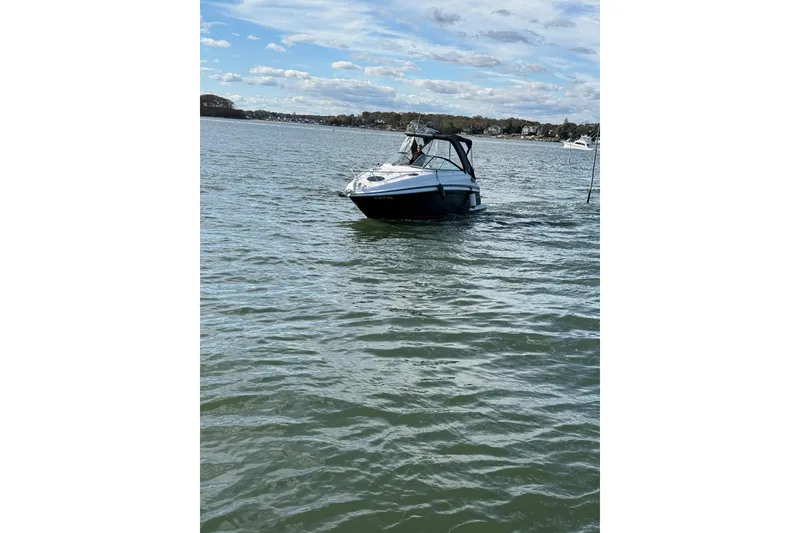 Slide: The Image of 2017 Regal 28 Express boat docked in marina, featuring sleek design and spacious seating. - 3