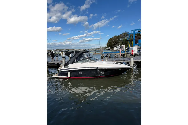 Slide: The Image of 2017 Regal 28 Express boat bathroom with toilet, sink, and mirror. - 30