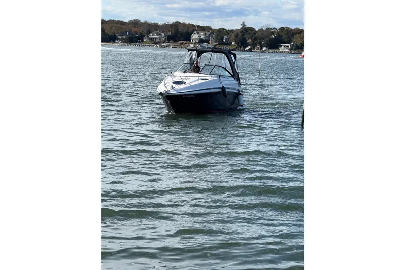 Slide: The Image of 2017 Regal 28 Express boat helm with Garmin navigation system and steering wheel. - 7