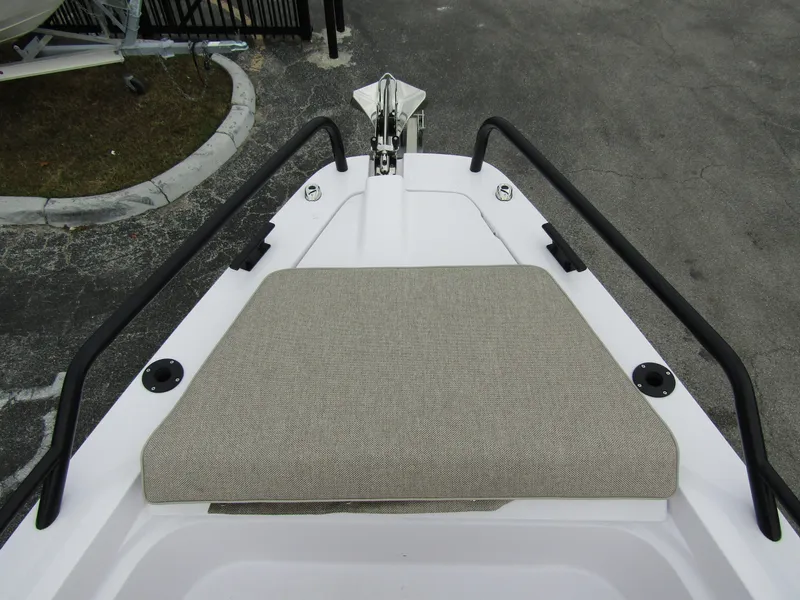 Slide: The Image of 2024 Axopar 37 Sun Top bow with cushioned seating and sleek railings. - 16