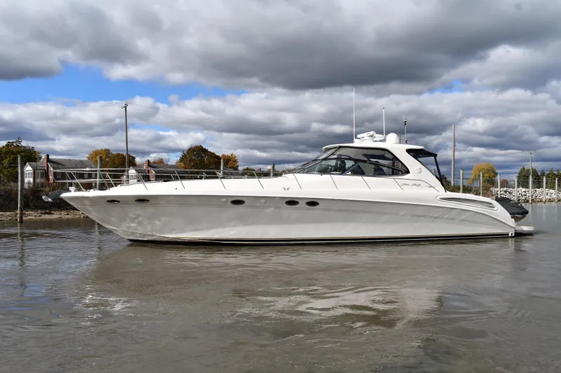 The Image of 2001 Sea Ray 540 Sundancer yacht on calm water under cloudy sky. - 0
