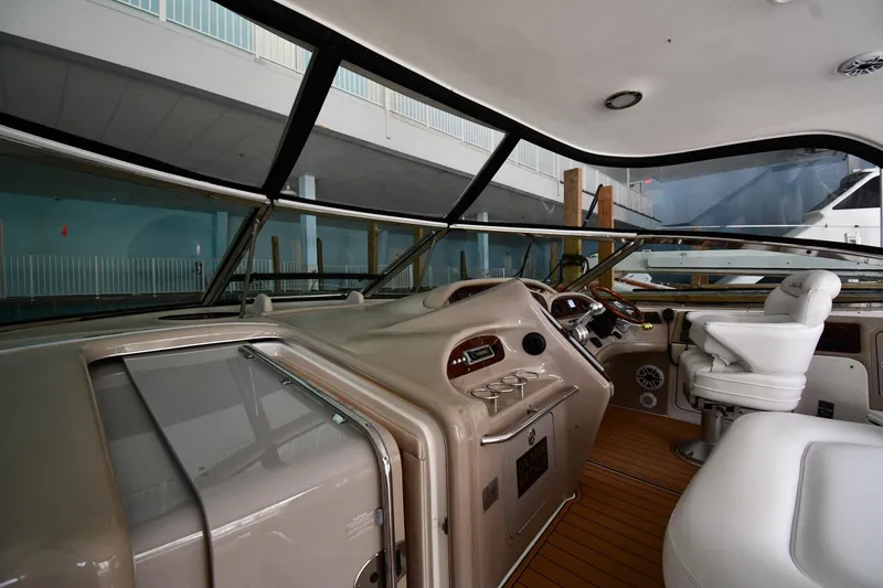 Slide: The Image of Interior view of 2001 Sea Ray 540 Sundancer yacht cockpit with steering and seating. - 10