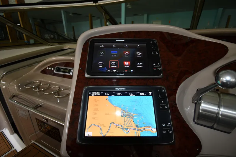 Slide: The Image of Helm of 2001 Sea Ray 540 Sundancer with navigation screens and controls. - 12