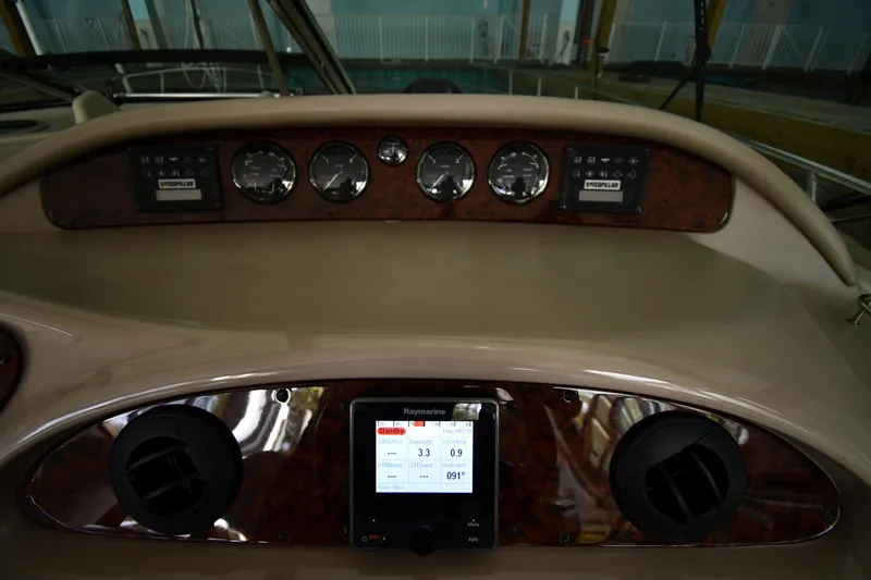 Slide: The Image of Helm dashboard of 2001 Sea Ray 540 Sundancer with gauges and Raymarine display. - 13