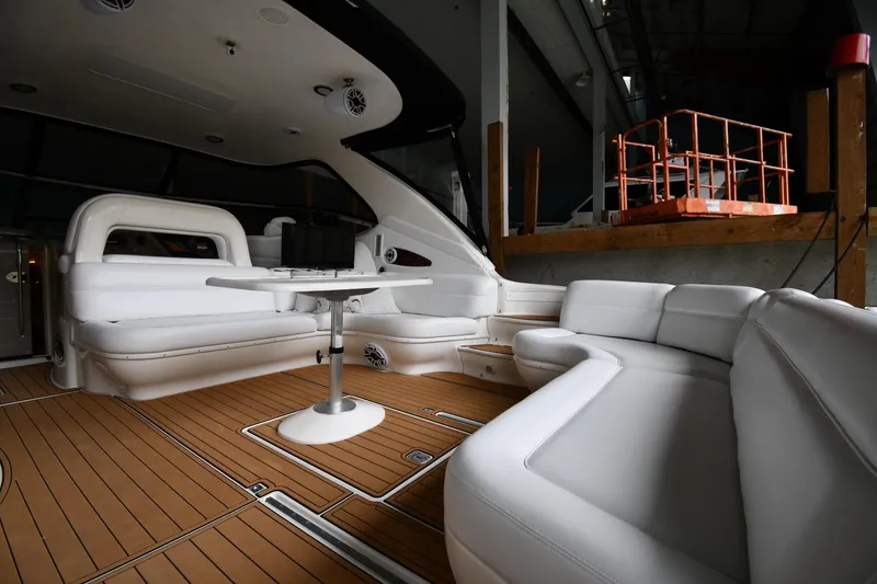 Slide: The Image of Luxurious interior of 2001 Sea Ray 540 Sundancer yacht with white seating and wooden flooring. - 17