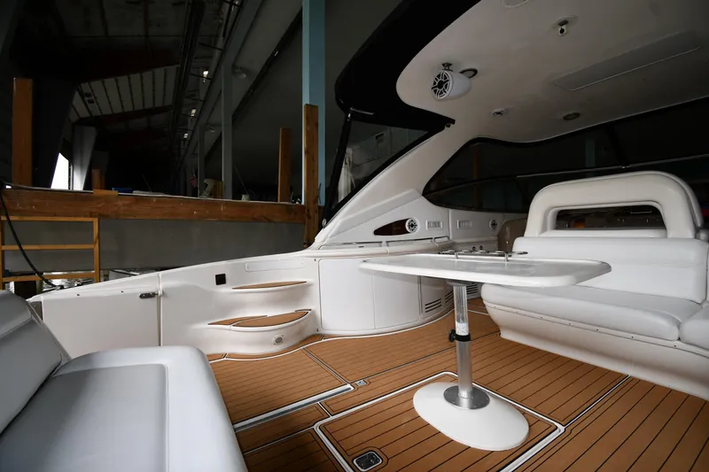 Slide: The Image of Luxurious interior of 2001 Sea Ray 540 Sundancer yacht with white seating and wooden flooring. - 18