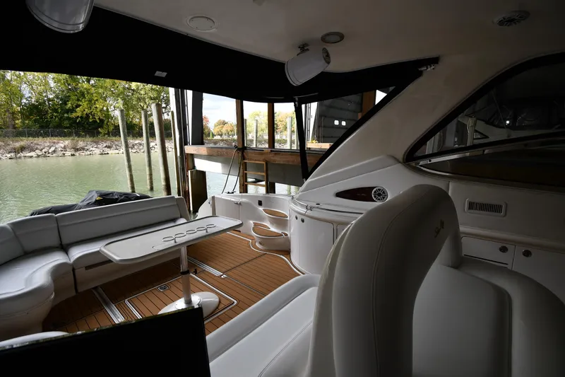 Slide: The Image of Interior of 2001 Sea Ray 540 Sundancer yacht with elegant seating and table setup. - 19