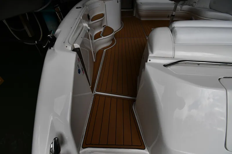 Slide: The Image of 2001 Sea Ray 540 Sundancer boat interior with sleek white seating and wood-style flooring. - 26