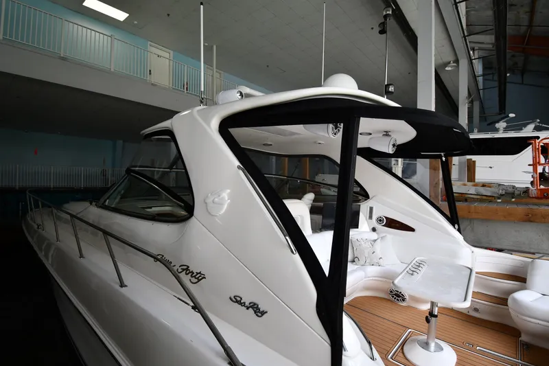 Slide: The Image of 2001 Sea Ray 540 Sundancer yacht in indoor storage, showcasing sleek design and luxury features. - 4