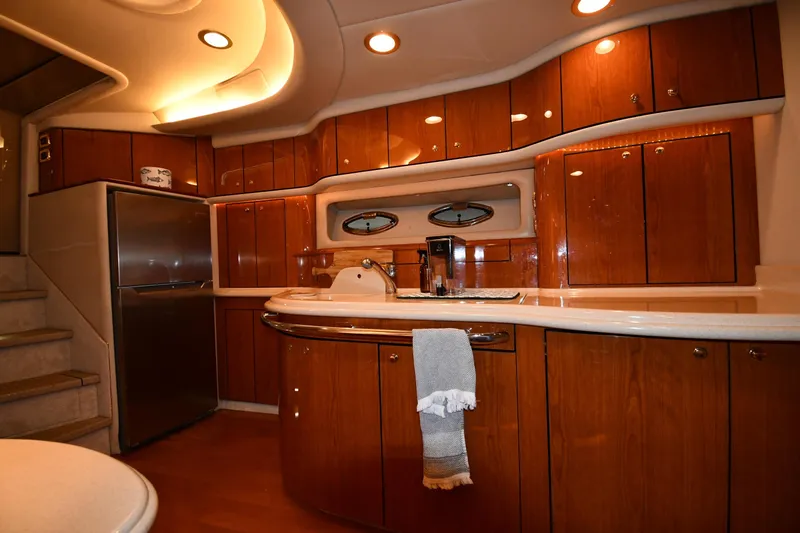 Slide: The Image of Luxurious 2001 Sea Ray 540 Sundancer yacht kitchen with wood cabinetry and modern appliances. - 42