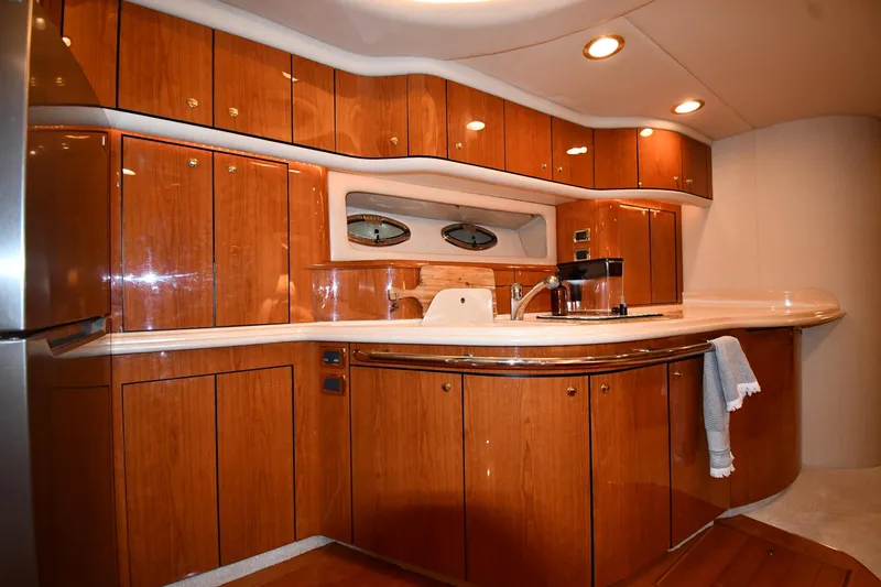 Slide: The Image of Luxurious 2001 Sea Ray 540 Sundancer yacht interior with elegant wooden cabinetry and modern amenities. - 43