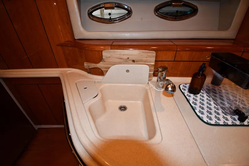 Slide: The Image of Luxurious 2001 Sea Ray 540 Sundancer yacht interior with elegant sink and wooden cabinetry. - 44