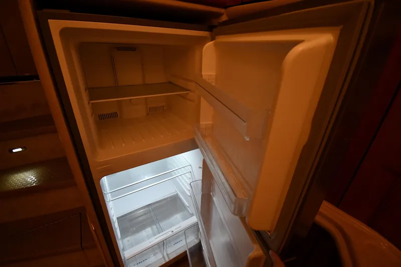Slide: The Image of Open refrigerator inside 2001 Sea Ray 540 Sundancer yacht, showcasing spacious interior. - 47