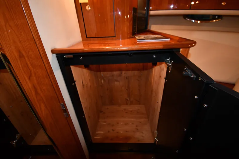 Slide: The Image of 2001 Sea Ray 540 Sundancer interior with open wooden cabinet and polished surfaces. - 55