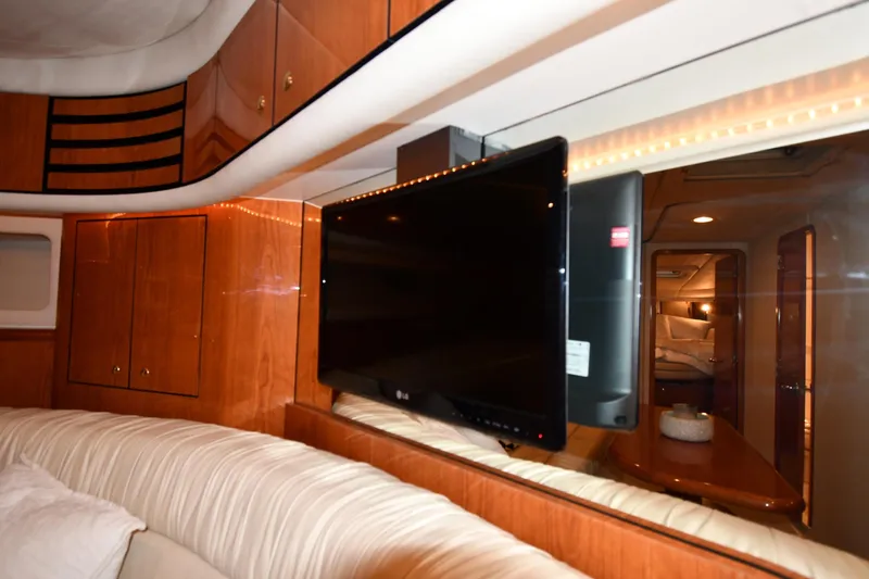 Slide: The Image of Luxurious interior of 2001 Sea Ray 540 Sundancer yacht with TV and wood cabinetry. - 56