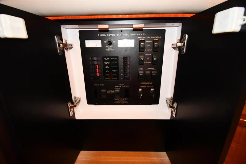Slide: The Image of Electrical distribution panel on 2001 Sea Ray 540 Sundancer yacht, showcasing controls and switches. - 57