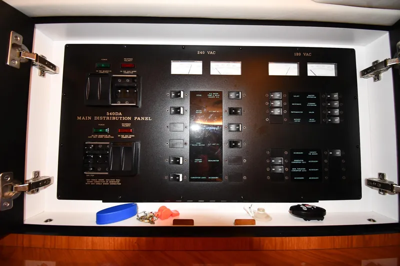 Slide: The Image of Main distribution panel of 2001 Sea Ray 540 Sundancer yacht, featuring various switches and meters. - 58