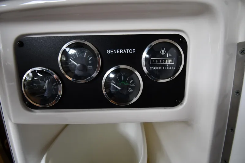 Slide: The Image of Control panel of a 2001 Sea Ray 540 Sundancer showing generator gauges. - 59