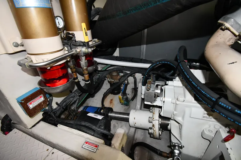 Slide: The Image of Engine room of 2001 Sea Ray 540 Sundancer with visible components and hoses. - 65