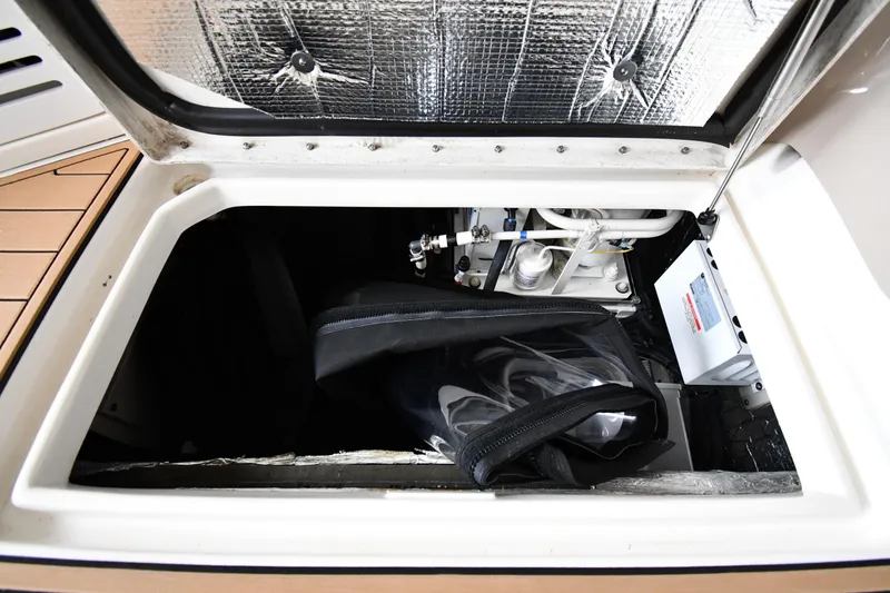 Slide: The Image of Storage compartment of a 2001 Sea Ray 540 Sundancer boat, showing equipment and insulation. - 74