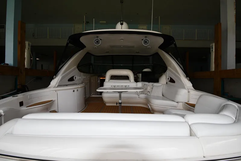 Slide: The Image of 2001 Sea Ray 540 Sundancer yacht interior with white seating and wooden flooring. - 9