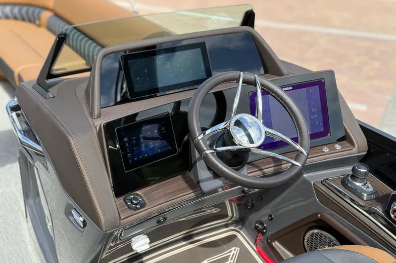 Slide: The Image of 2026 Bennington 30 QXSBAX2 boat dashboard with modern steering and digital displays. - 17