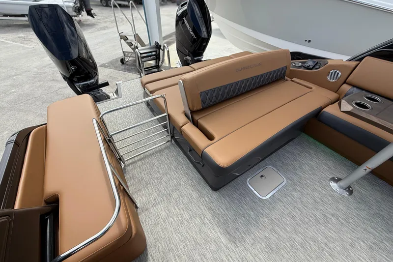Slide: The Image of 2026 Bennington 30 QXSBAX2 boat interior with tan seating and dual outboard motors. - 23